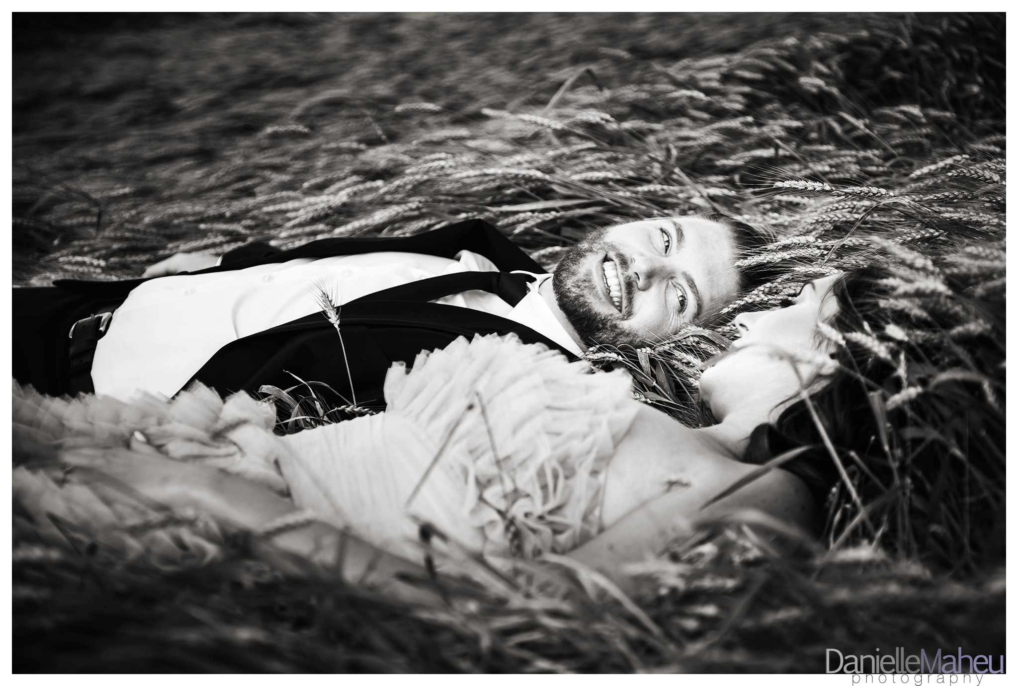 Engaged couple in a wheat field in a pink designer gown at Ivy Ridge wedding venue in Thornton Ontario