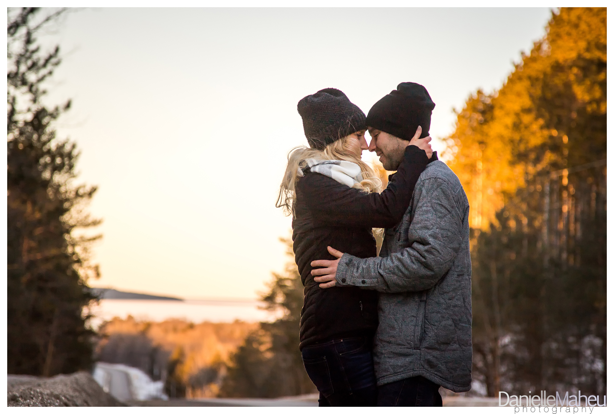 Engage couple embrace in winter near a county road