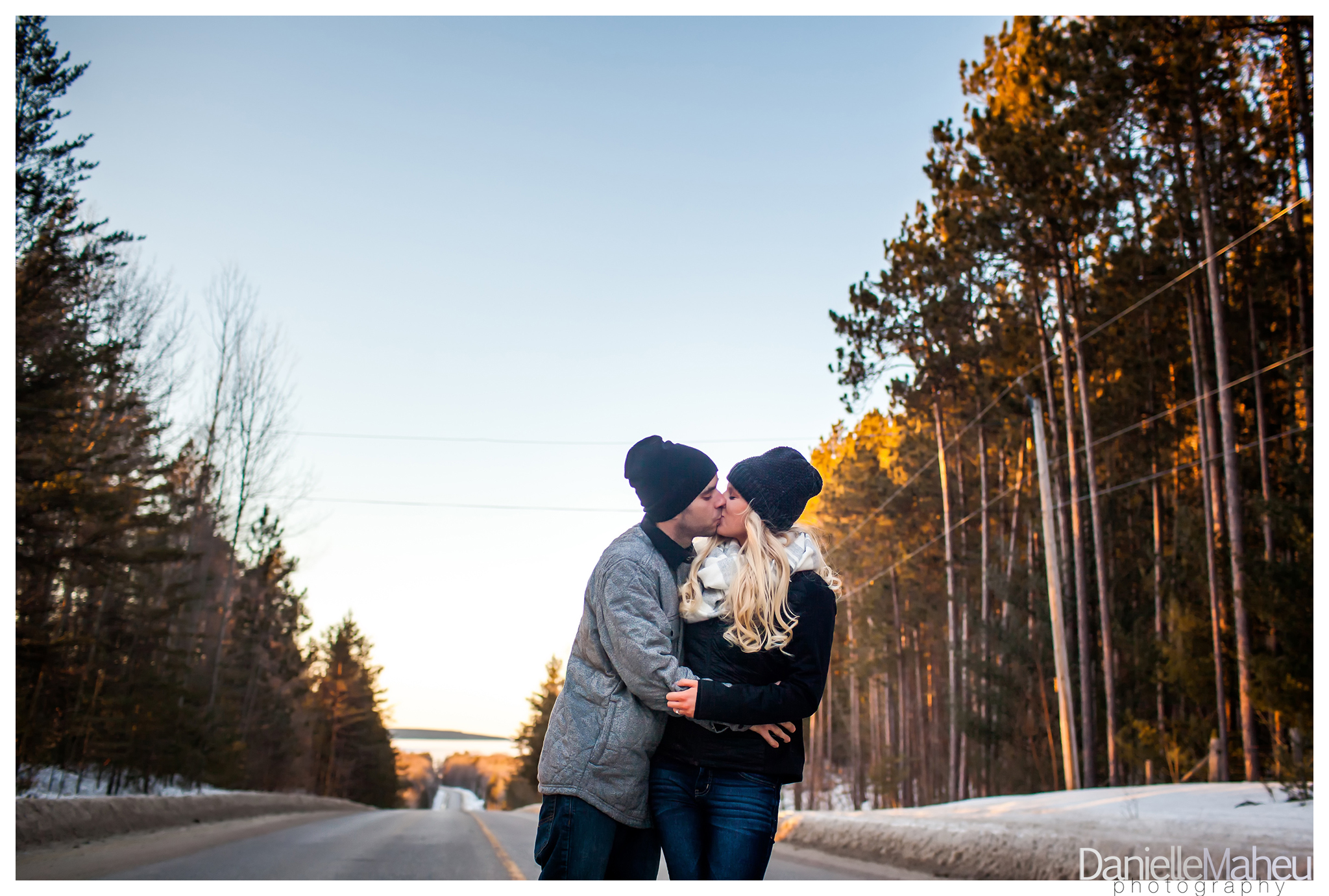 Engage couple embrace in winter near a county road